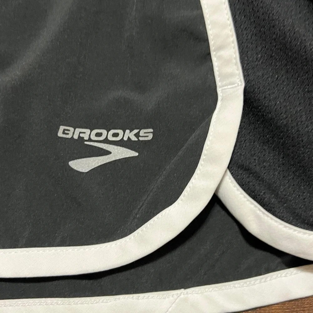 Brooks black running shorts with white side stripes 314.5